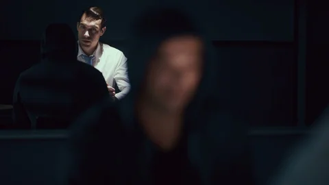 Criminal being interviewed in the interrogation room Stock Footage 106829132
