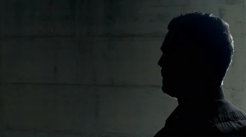 Criminal clandestine being interviewed dark room 4k Stock Footage 47125446