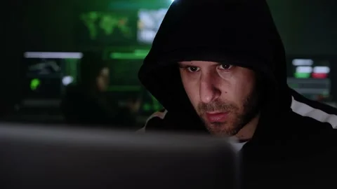 Criminal Hacker using computer for organizing massive data breach attack on Stock Footage 207244027