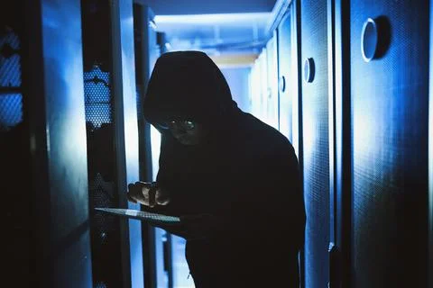 Criminal, hacking and tablet in data center at night for malware, cyberatta.. 스톡 사진