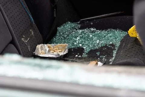 Criminal incident. Car hack. Broken left side window of car. Stock Photos