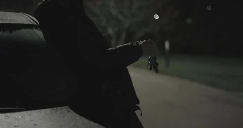 Criminal man plays with car keys Stock Footage 274062453
