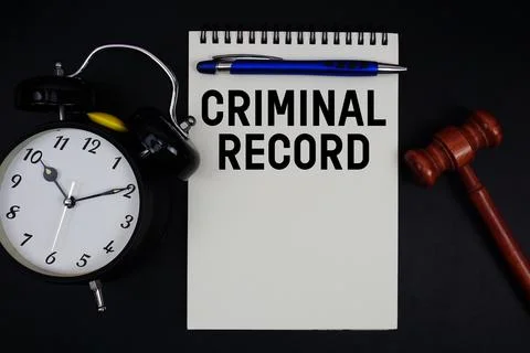 Criminal Record text written on notepad with gavel and alarm clock on black.. Stockfoto's