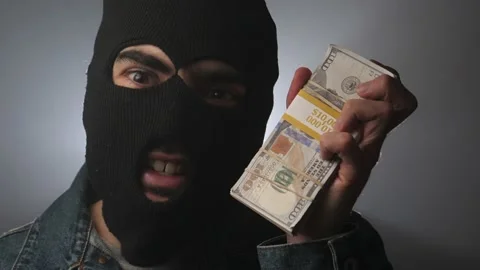 Criminal Robber Holding a Stack of Money in His Hand Stock Footage 148754872