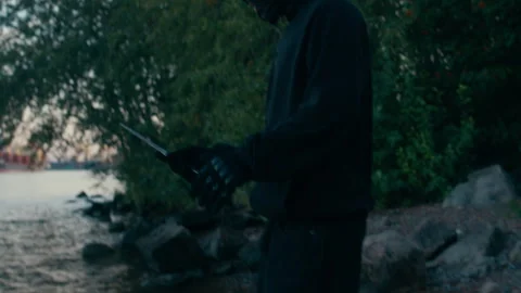 Criminal Running Away from Cops and Throwing Knife in Water Stock Footage 290518821
