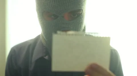 Criminal terrorist reading note read Stock Footage 12096018