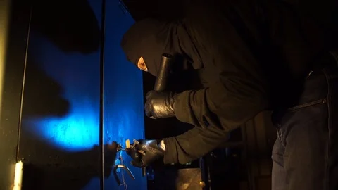 The criminal thief opens the safe in the dark night Stock Footage 69882547