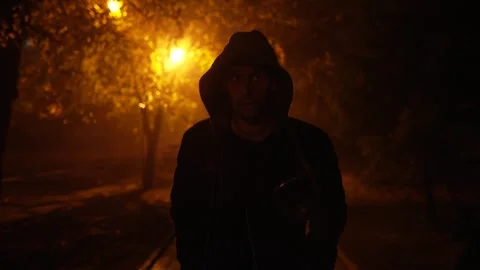 Criminal walks down a dark street Stock Footage 290847876