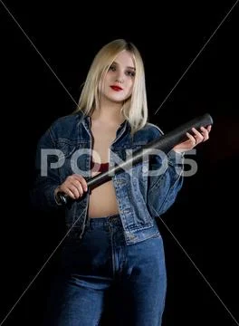 Criminal young woman with baseball bat, young hooligan in jeans and a denim Stock Photos