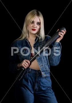 Criminal young woman with baseball bat, young hooligan in jeans and a denim Stock Photos