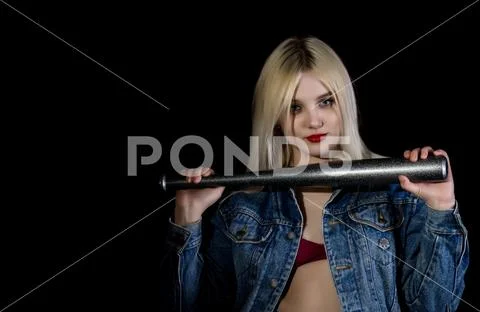 Criminal young woman with baseball bat, young hooligan in jeans and a denim Stock Photos