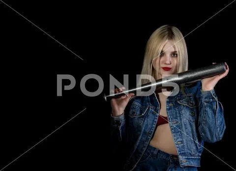 Criminal young woman with baseball bat, young hooligan in jeans and a denim Stock Photos
