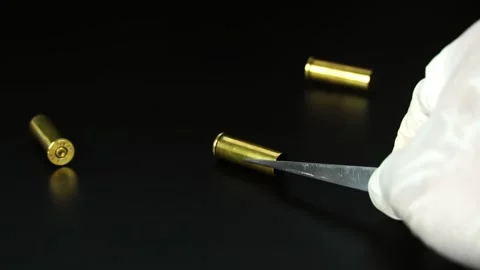 The criminologist is checking the ammunition from the scene. Stock Footage 169209260