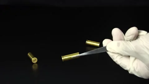 The criminologist is checking the ammunition from the scene. Stock Footage 169209282