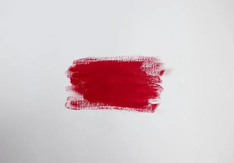 Crimson red paint patch on plain white background with copy space Stock Photos