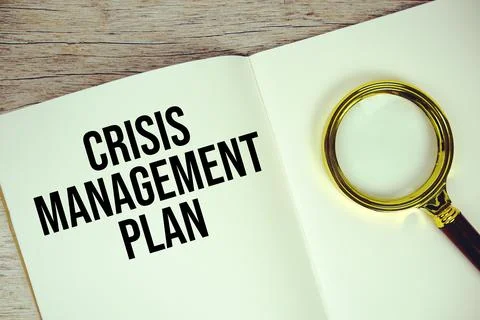 Crisis Management Plan text written on chalkboard with alarm clock on woode.. Stock Photos
