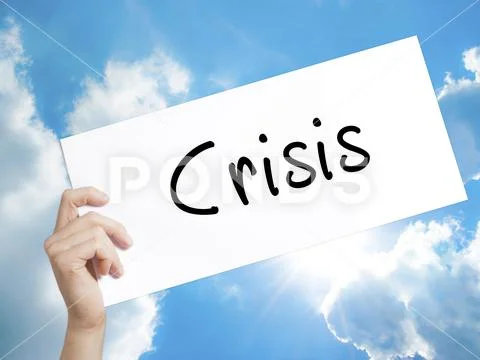 Crisis Sign on white paper. Man Hand Holding Paper with text. Is Stock Photos