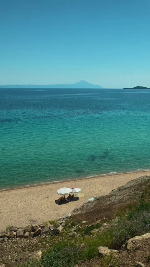 Crisp blue sky frames turquoise sea. Trani Ammouda, Greece. Vertical Stock Footage 339630002