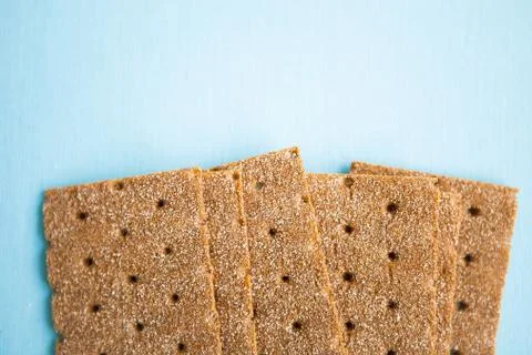 Crisp bread on the blue background. Corn dodger. Crackers. Loaf of bread. Stock Photos