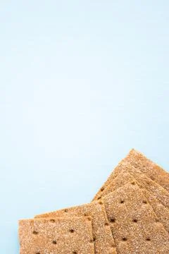 Crisp bread on the blue background. Corn dodger. Crackers. Loaf of bread. Stock Photos
