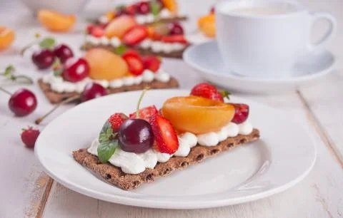 Crisp bread with creme cheese, fruit and berries Stock Photos