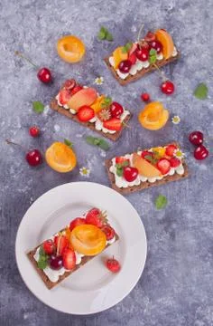Crisp bread with creme cheese, fruit and berries Stock Photos