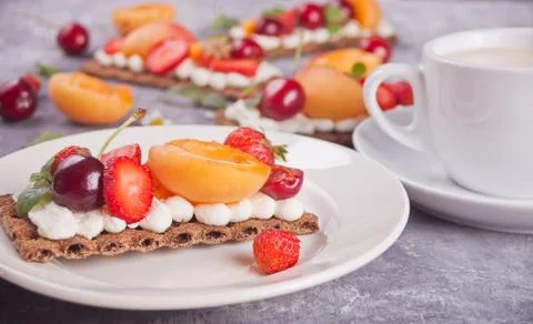 Crisp bread with creme cheese, fruit and berries Stock Photos