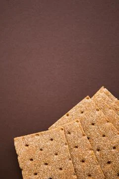 Crisp bread on the dark brown background. Corn dodger. Crackers. Loaf of brea Foto stock