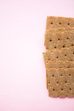 Crisp bread on the pink background. Corn dodger. Crackers. Loaf of bread. Stock Photos