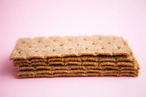 Crisp bread on the pink background. Corn dodger. Crackers. Loaf of bread. Stock Photos