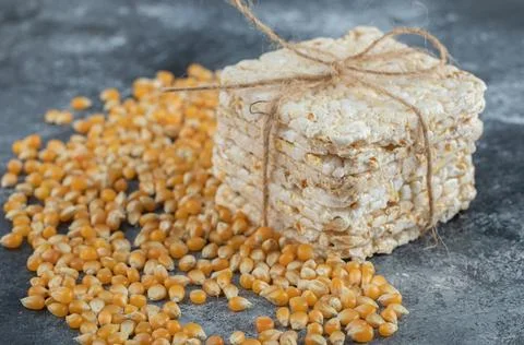Crisp bread in rope with uncooked popcorn seeds Stock Photos