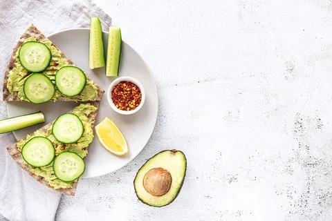Crisp bread sandwiches with mashed avocado and cucumber Foto stock