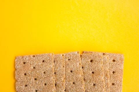 Crisp bread on the yellow background. Corn dodger. Crackers. Loaf of bread. Stock Photos