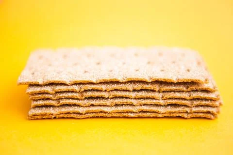 Crisp bread on the yellow background. Corn dodger. Crackers. Loaf of bread. Stock Photos