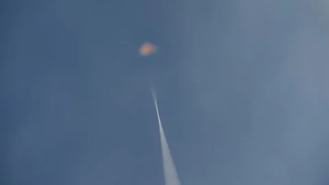 Crisp string in focus as a distant kite ascends, set against a dreamy, clouded Stock Footage 313138922