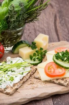 Crispbread with cheese on a board Stock Photos