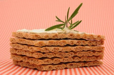 Crispbread with cream cheese, on a checkered table cloth 스톡 사진