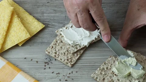 Crispbread with creamy cheese on the table Stock Footage 203817345