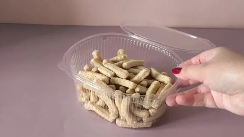 Crispbread in an open plastic container in a womans hand close-up. Healthy Stock Footage 324770010