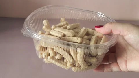 Crispbread in a plastic container in a womans hand. The benefits of whole-grain Stock Footage 324770027