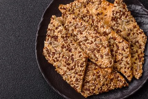 Crispbread, thin bread with seeds and grains, a baked cracker. Crispbread w.. Stock Photos