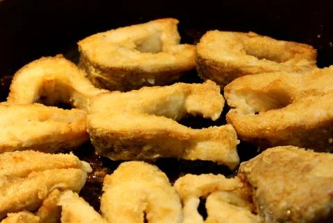 Crispy appetizing fried pieces of fish Stock Photos