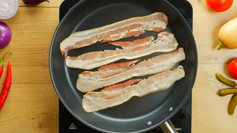 Crispy bacon frying on a pan Stock Footage 108091310