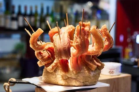 Crispy bacon pinchos served on bread in a bar Stock Photos