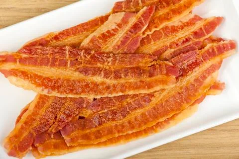 Crispy bacon rashers prepared on a platter Stock Photos