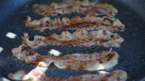 Crispy Bacon Slices are Fried in a Hot Pan Stock Footage 199129818