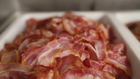 Crispy bacon strips piled in white dish Stock Footage 341971074