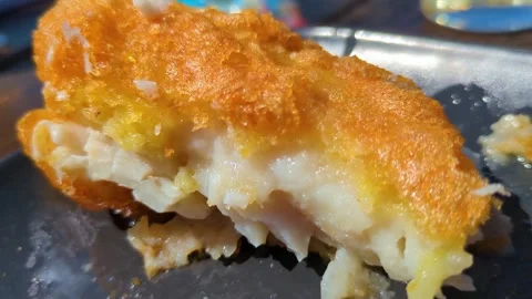 Crispy Battered Classic British Cod Fish in Natural Sunlight. Traditional Fast Stock Footage 310366311