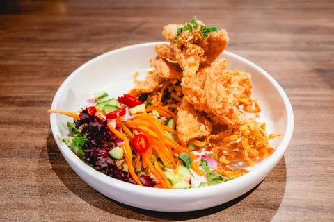 Crispy battered squid on a white plate. Stock Photos