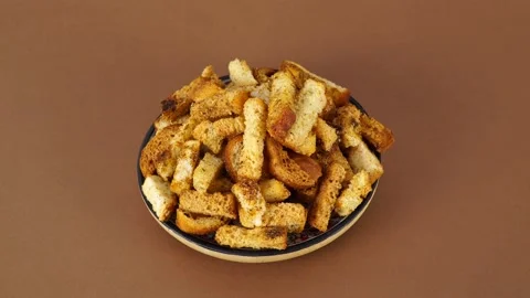 Crispy bread cubes, dry re crumbs, crouton or brown roasted tostes rotating o Stock Footage 157367347